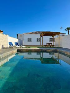 a swimming pool in front of a white building at Casa caminito 2 in Zahora