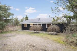 a house with two hay bales on the side of it at 239-Ringkobing-Vestklitvej-32 in Klegod