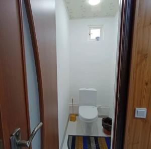 a small bathroom with a white toilet in a room at Guesthouse'Hadicha' in Tong +28 photos