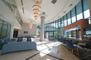 a lobby with chairs and a bar in a building at BLUE MUDANYA HOTEL in Bursa