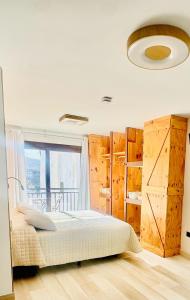 a bedroom with a bed and a large window at Hostal ZENTRAL in Alora