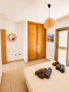 a bedroom with a bed with three pillows on it at Aurea 1 Luxury House in Antigua +29 photos