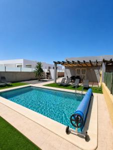 a swimming pool with a blue slide in a yard at Aurea 1 Luxury House in Antigua