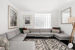 a living room with a couch and a rug at Peggy - Little Cove in Noosa Heads