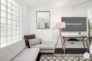a living room with a couch and a table at Peggy - Little Cove in Noosa Heads