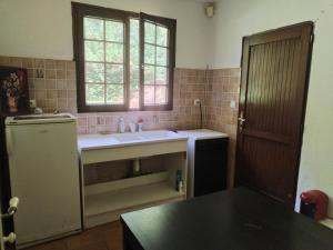 a small kitchen with a sink and a window at Maison indépendante studio calme et confort in Ervauville