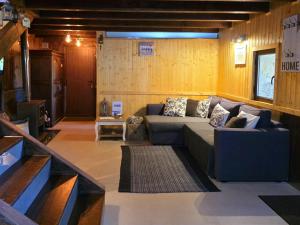 a living room with a couch and a television at Casa das Candeias in Melgaço