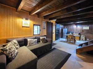 a living room with a couch and a kitchen at Casa das Candeias in Melgaço