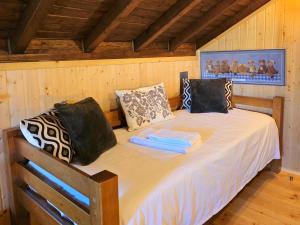 a bedroom with a bed in a wooden room at Casa das Candeias in Melgaço
