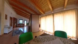 a dining room with a table and green chairs at La quiete dell'Ammiraglio 2 in Ioppolo +16 photos