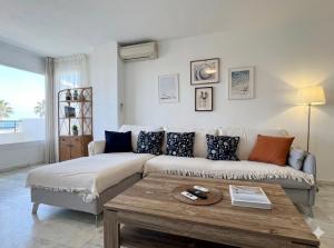 a living room with a couch and a coffee table at Sunset Torrox Costa in Torrox