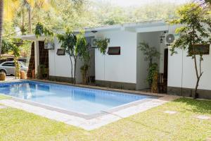 a swimming pool in front of a house at Rayonaz Resort in Dambulla