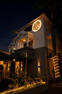 a building with a clock on the side of it at night at The L Boutique Tz in Dar es Salaam