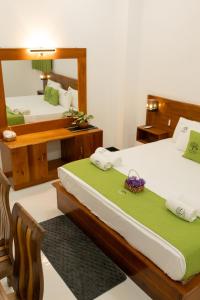 a bedroom with two beds and a mirror at Rayonaz Resort in Dambulla +18 photos