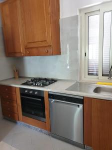 a kitchen with a stove and a sink at Sperlonga ad un passo Casa Vacanza in Sperlonga