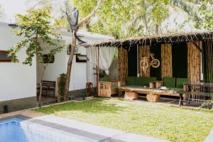 a patio with a table and chairs next to a pool at Rayonaz Resort in Dambulla