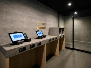 a lobby with two computers on a counter at Minn Sapporo Odori W14 in Sapporo