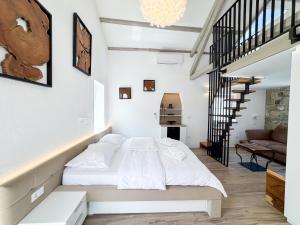 a bedroom with a bed and a staircase at Gloria Holiday - Villa di Istria in Piran +52 photos