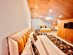 a living room with two beds and a couch at Hadimba Palace, Manali in Manāli