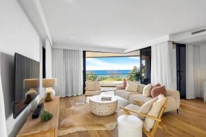 a living room with a couch and a table at Coolum First Bay 121 in Coolum Beach