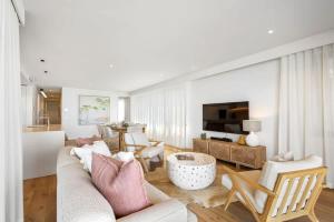 a living room with a couch and a table at Coolum First Bay 121 in Coolum Beach +18 photos