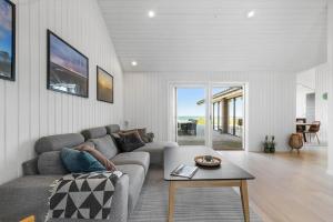 a living room with a couch and a table at 8535-Glesborg-Havstokken-12 in Glesborg