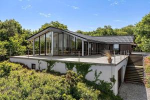 a house with glass walls and a roof at 8535-Glesborg-Havstokken-12 in Glesborg
