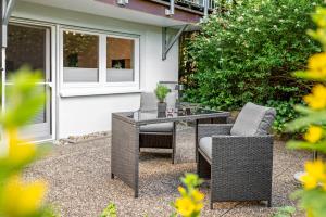 a patio with a table and chairs on a gravel yard at O'Schwarzwald in Münstertal