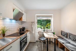 a kitchen with a table and chairs and a window at O'Schwarzwald in Münstertal