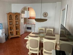 a kitchen with a table and chairs and a dining room at Apartment Dorada in Dobra Voda
