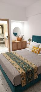 a bedroom with a large bed and a mirror at Apeiron Acropolis Suites by HC in Athens