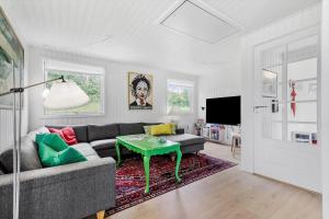 a living room with a couch and a table at 84159-Ebeltoft-Koravej-5 in Ebeltoft