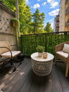 a patio with a table and chairs on a deck at Adam's Pension in Chemnitz