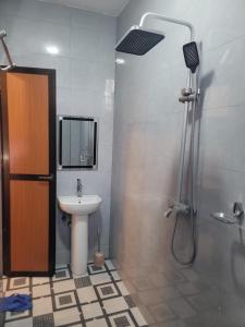 a bathroom with a sink and a shower with a shower at Moveck Inn in Dar es Salaam +5 photos