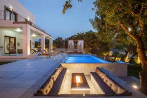 a backyard with a swimming pool and a house at Kallisti Luxury Villa in Kallithea Rhodes