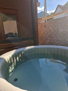 a hot tub in the backyard of a house at Tri ville in Žabljak