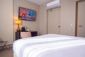 a bedroom with a bed and a tv on the wall at Hotel Frochot Montmartre in Paris +25 photos