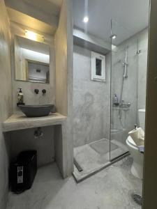 a bathroom with a sink and a glass shower at Vista Mare in Naousa +70 photos