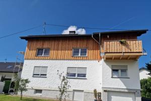 a building with a deck on top of it at NEU! Ferienwohnung Beim Hubert in Waldbröl
