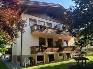 a building with balconies and flowers on it at Appartementhaus Grocke in Wagrain
