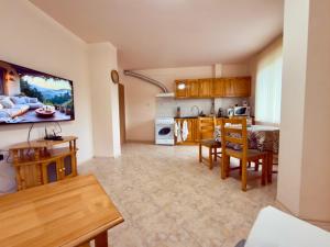 a kitchen and living room with a table and chairs at Panorama View-Stoykite in Stoykite