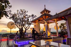 a restaurant on the roof of a building with a tree at Suvarnabhumi Suite Hotel - Suvarnabhumi Airport, Bangkok in Lat Krabang