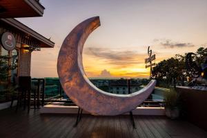a large wooden crescent shaped object sitting on a deck at Suvarnabhumi Suite Hotel - Suvarnabhumi Airport, Bangkok in Lat Krabang