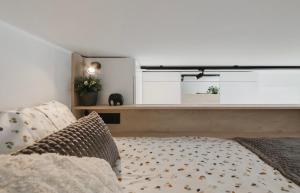 a living room with a bed and a large window at Cosy apartment in Vilnius