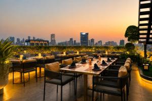 a restaurant with a view of the city at sunset at Harmony Phnom Penh Hotel in Phnom Penh