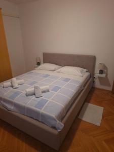 a bed with two towels on it in a room at Apartment Matea in Senj