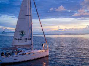 a group of people on a sail boat in the water at Palau Mangrove Hotel in Koror