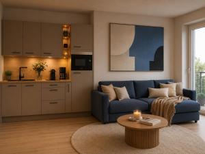 a living room with a blue couch and a table at Residenz Bergkristall in Saalbach-Hinterglemm