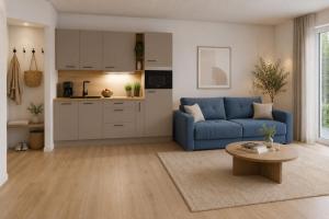 a living room with a blue couch and a kitchen at Residenz Bergkristall in Saalbach-Hinterglemm +10 photos