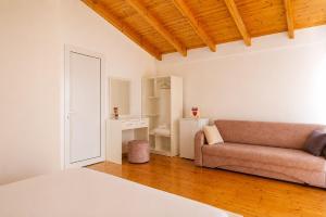 a living room with a couch and a mirror at PRIAM Beach Borsh in Borsh